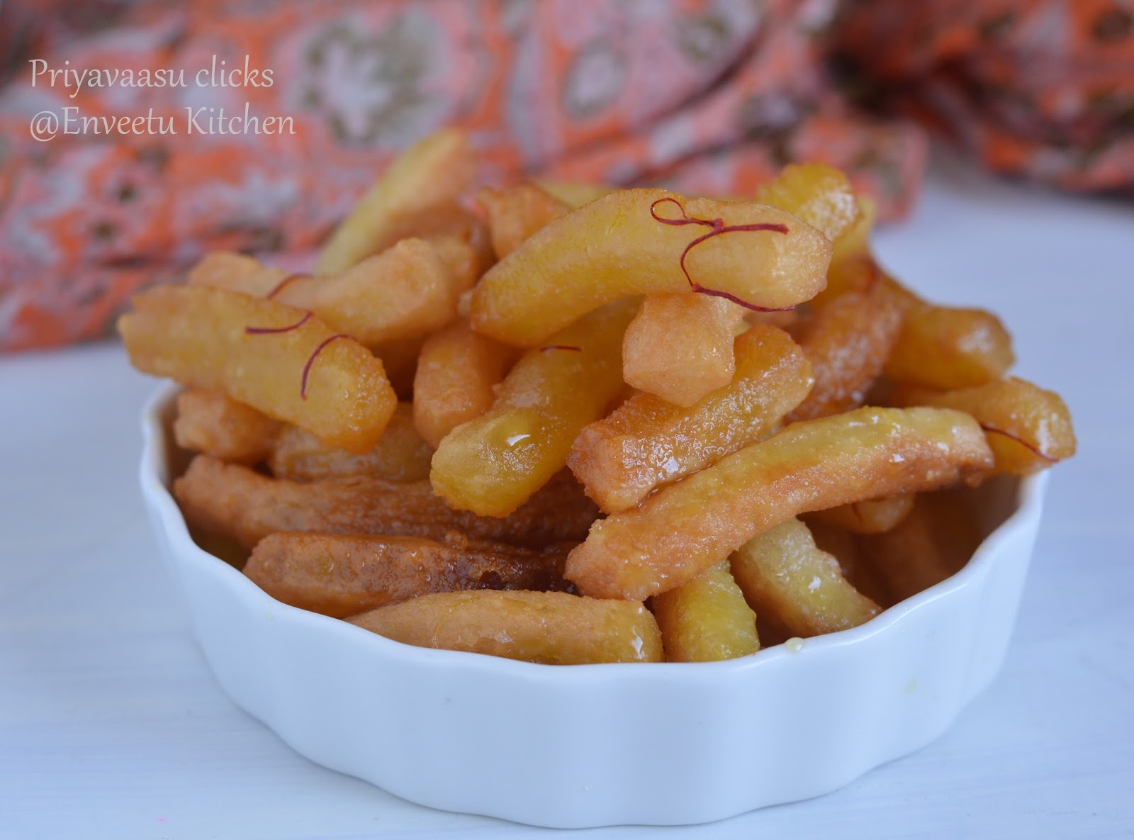 Persian Doughnuts in a white serving bowl with saffron as garnish