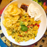 Easy capsicum rice served with curd, chips and pickle